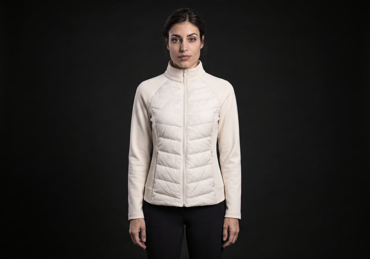 Velmurax women's down riding jacket in ivory, worn by the model in a front view on the dark studio set