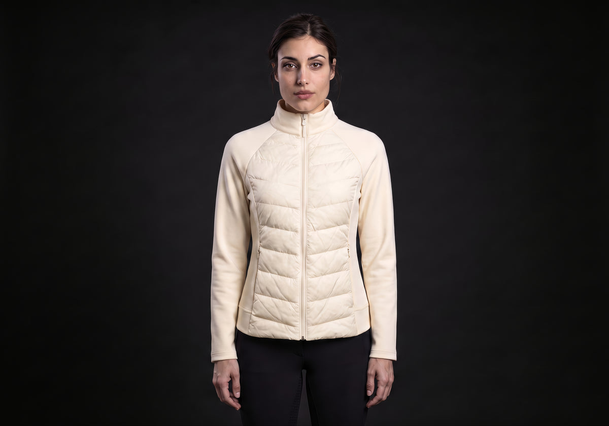 Velmurax women's down riding jacket in cream, worn by the model in a front view on the dark studio set