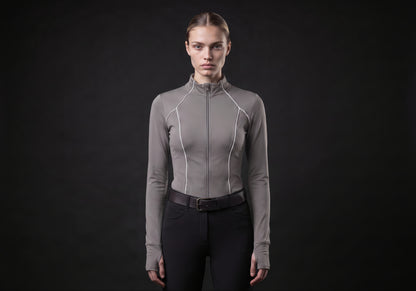 Velmurax women's long-sleeve riding top in gray, worn by the model in a front view on the dark studio set