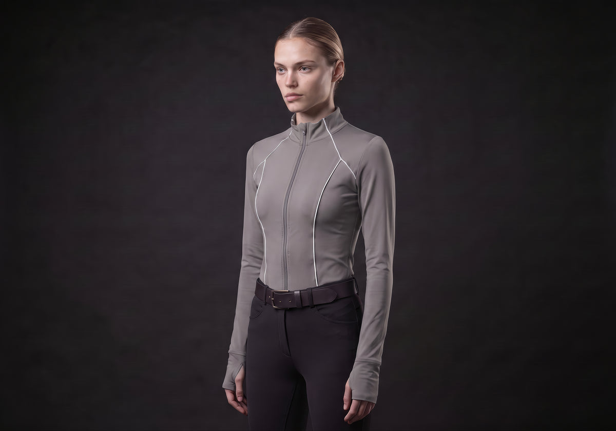 Velmurax women's long-sleeve riding top in gray, in a three-quarter view on the model on the studio set