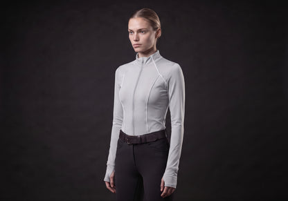 Velmurax women's long-sleeve riding top in light gray, in a three-quarter view on the model on the studio set