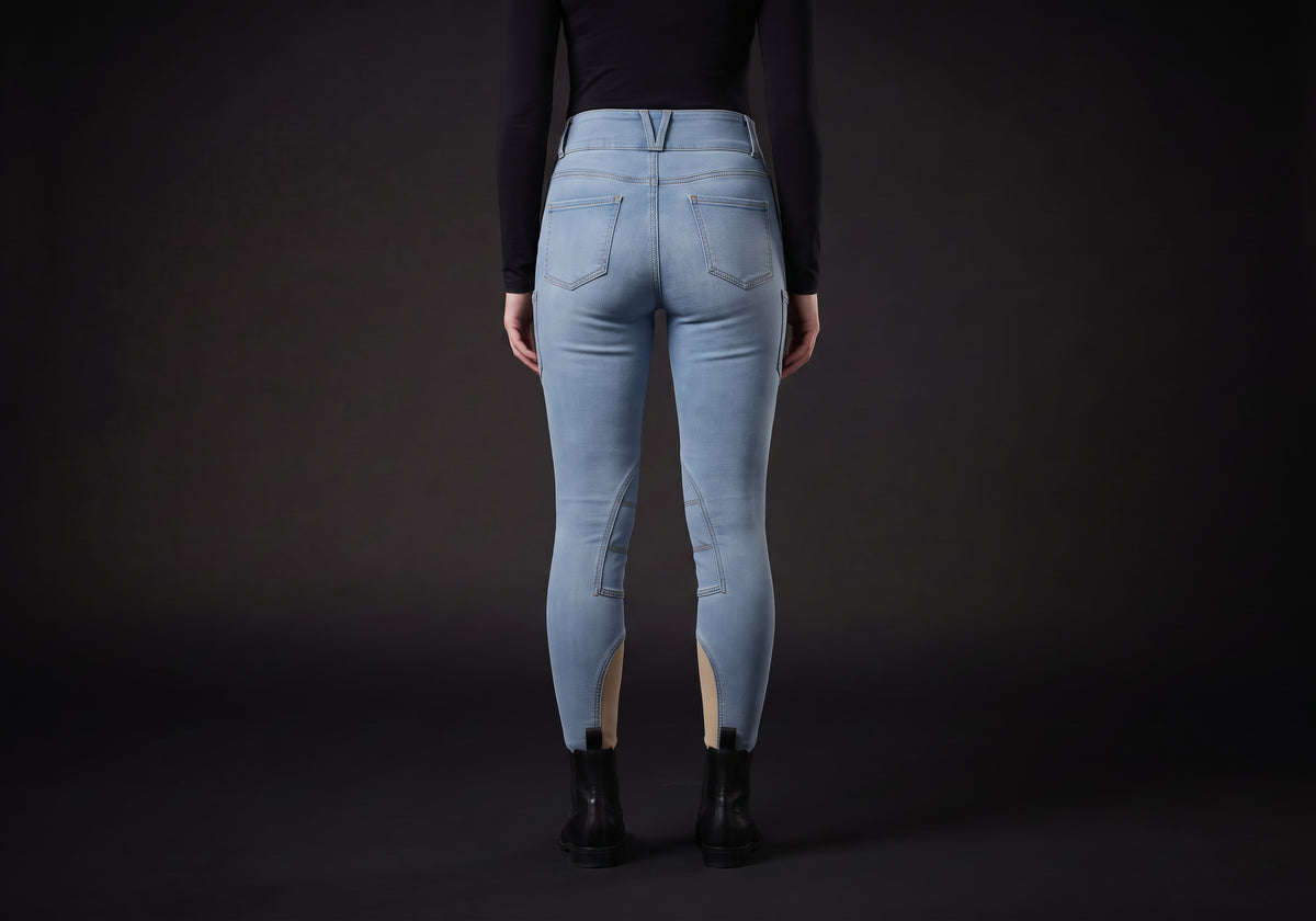 Velmurax women's high-waisted denim riding breeches in light blue, worn, seen from the back
