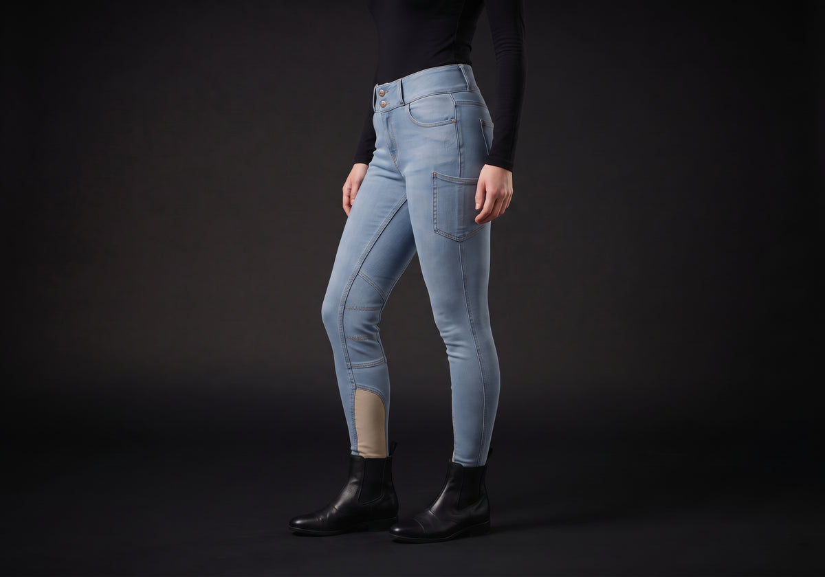 Velmurax women's high-waisted denim riding breeches in light blue, worn, in side profile