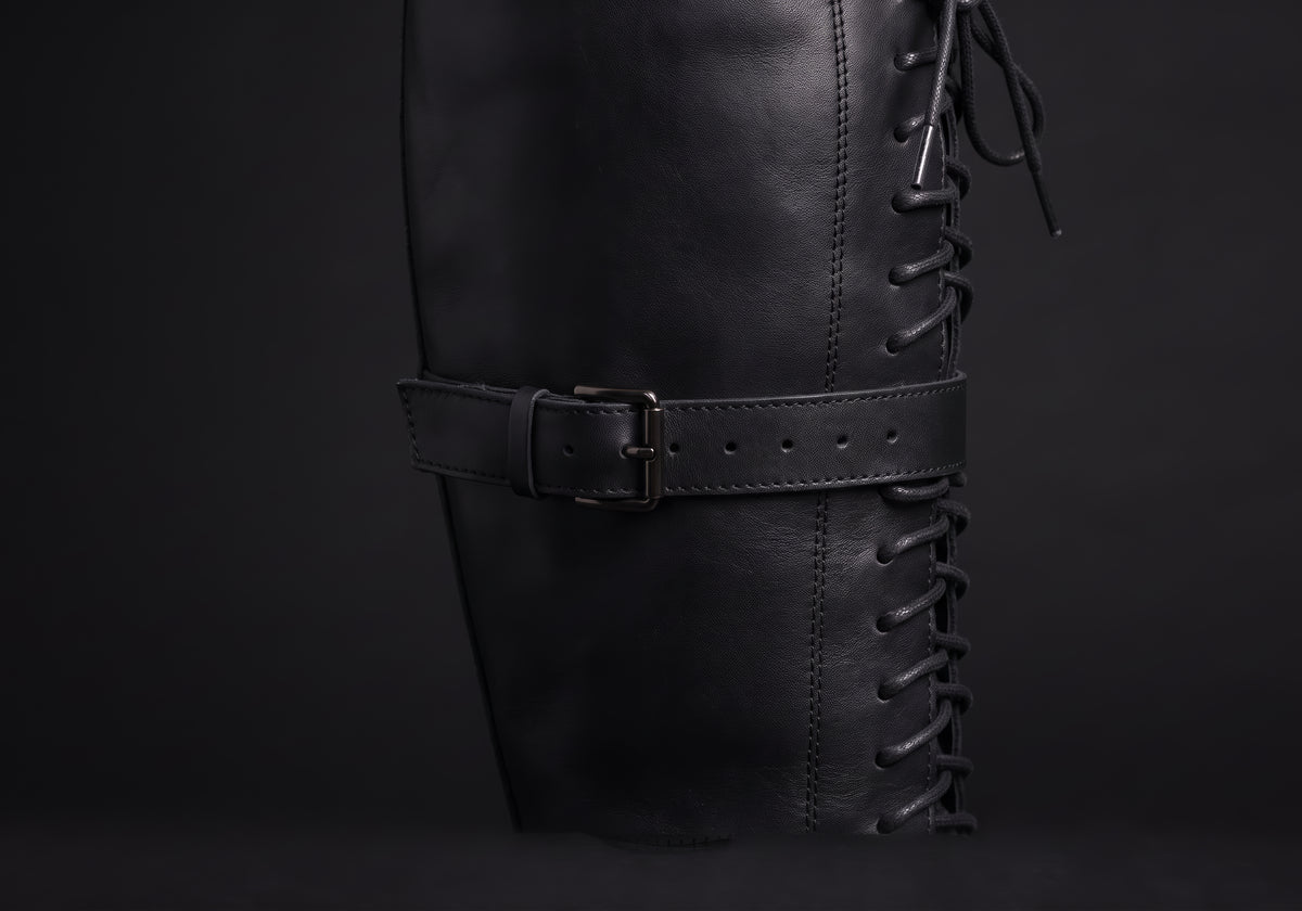 Velmurax women's lace-up knee-high boots in black, the closure up close, worn