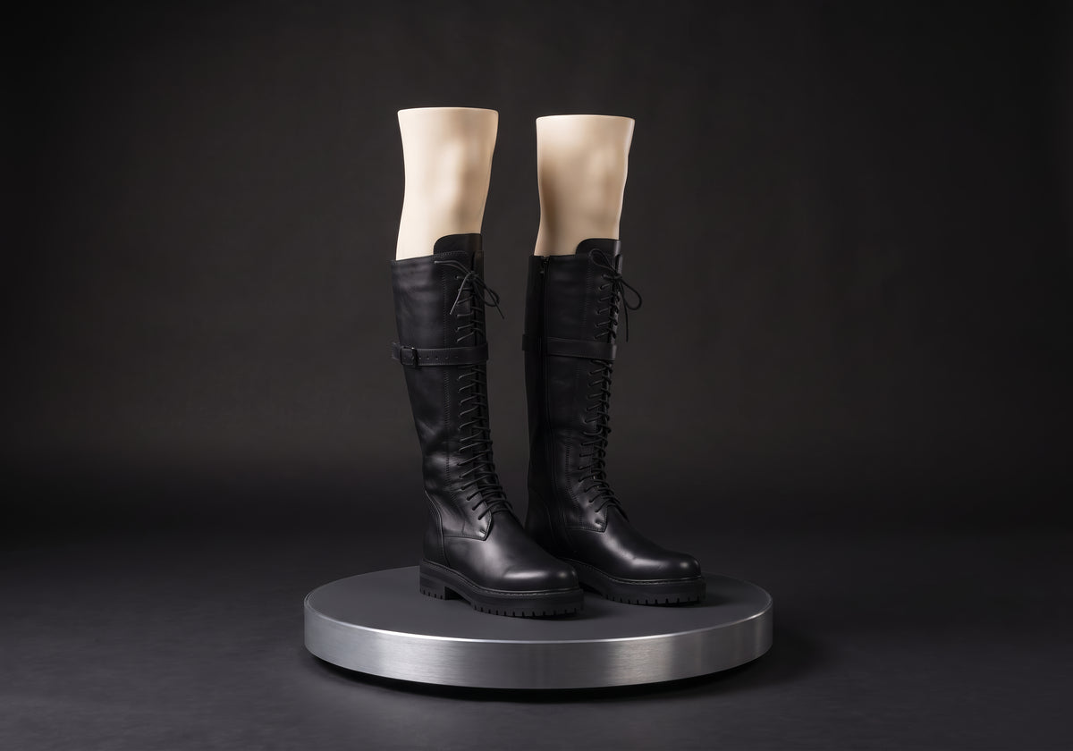 Velmurax women's lace-up knee-high boots in black, on a display mannequin on the studio turntable