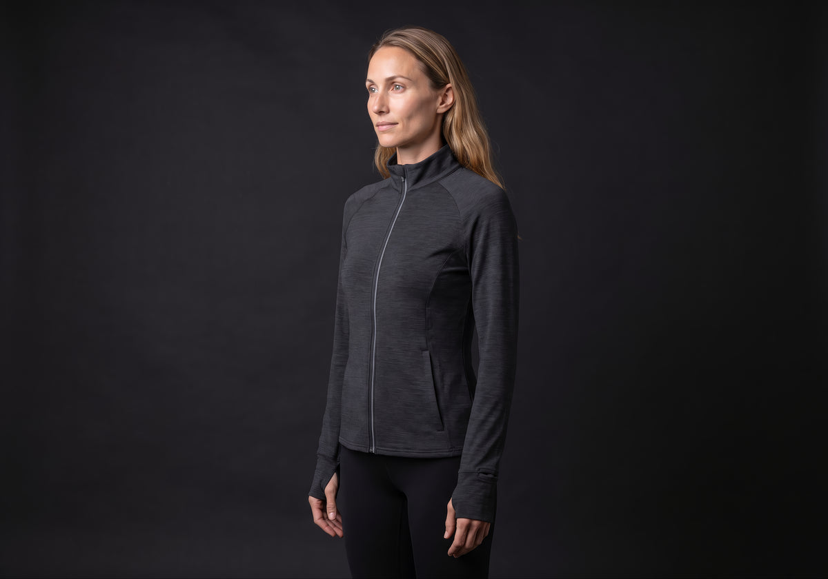Velmurax women's stretch track jacket in black, in a three-quarter view on the model on the studio set