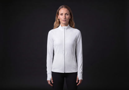 Velmurax women's stretch track jacket in white, worn by the model in a front view on the dark studio set
