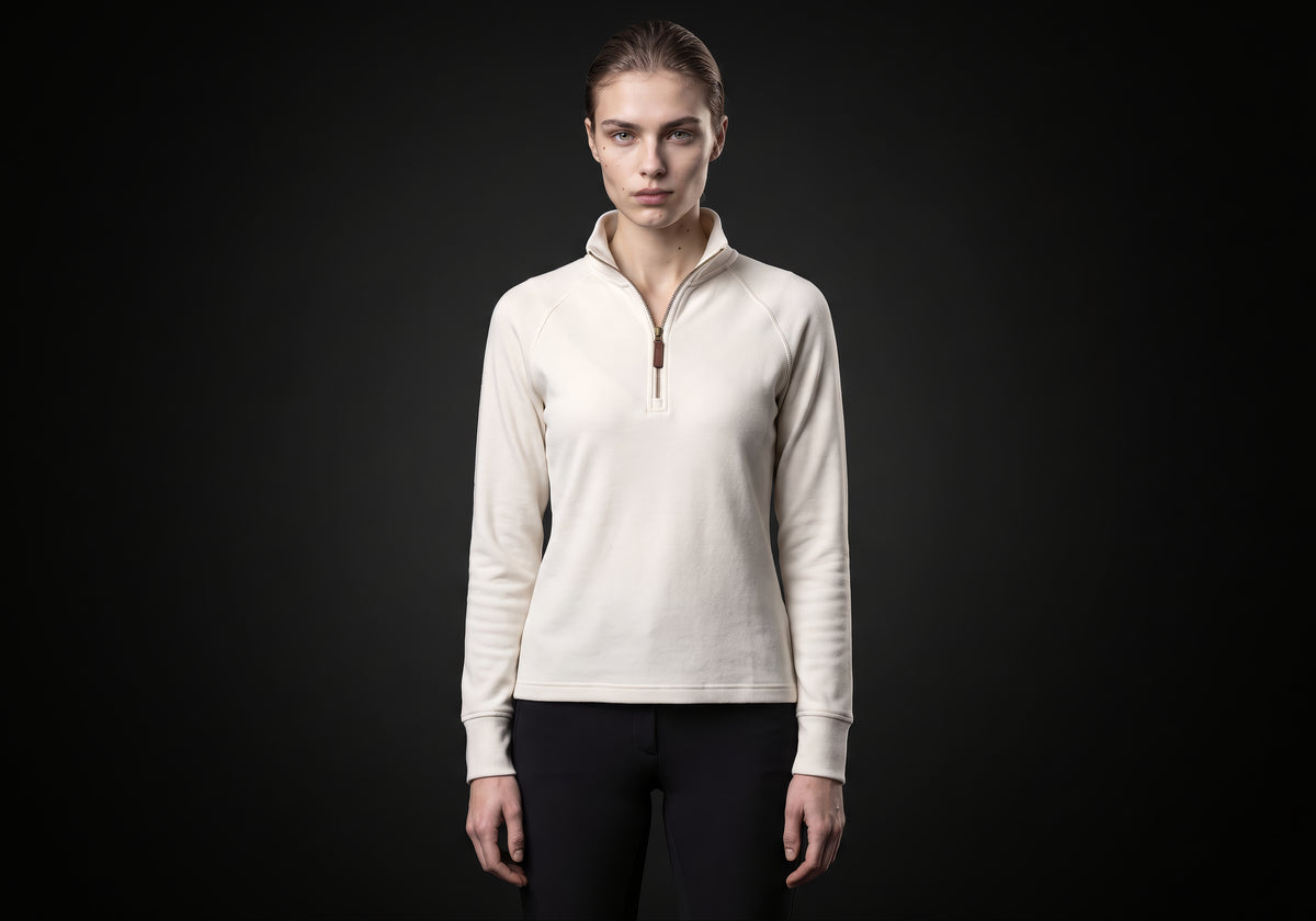 Velmurax women's thermal riding shirt in ivory, worn by the model in a front view on the dark studio set