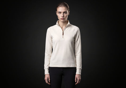 Velmurax women's thermal riding shirt in ivory, worn by the model in a front view on the dark studio set