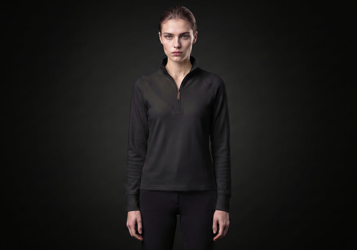 Velmurax women's thermal riding shirt in black, worn by the model in a front view on the dark studio set