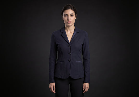 Velmurax women's show jacket in navy, worn by the model in a front view on the dark studio set