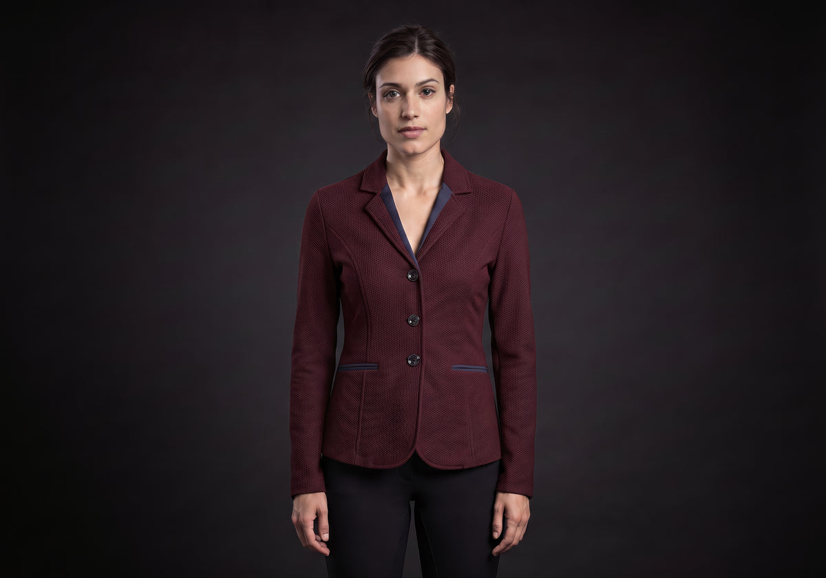 Velmurax women's show jacket in burgundy, worn by the model in a front view on the dark studio set