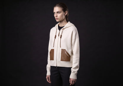 Velmurax wool cashmere zip hoodie in ivory, in a three-quarter view on the model on the studio set