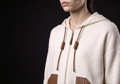 Velmurax wool cashmere zip hoodie in ivory, in a close detail shot on the model