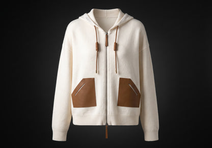 Velmurax wool cashmere zip hoodie in ivory, on its own on the dark studio set